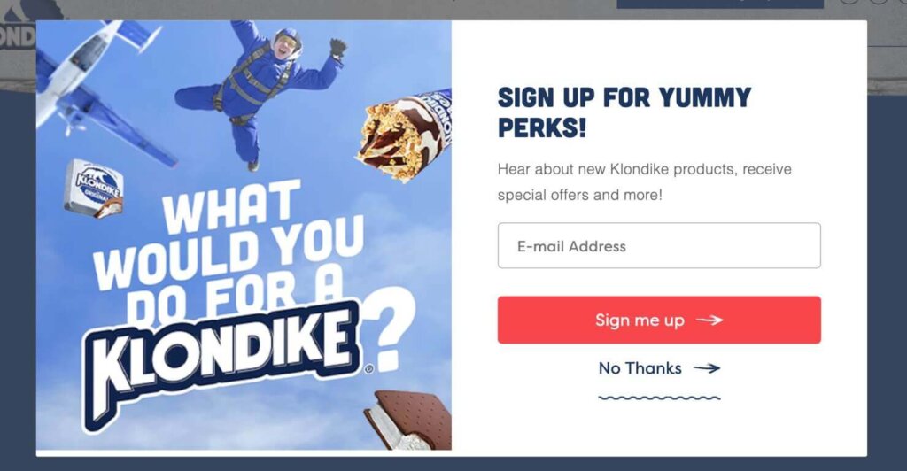Website popup with a photo of a person skydiving with the phrase. "What Would You Do for a Klondike?" over the photo. Beside the photo, the heading says "Sign up for yummy perks!" with an email address field and a "sign me up" button.